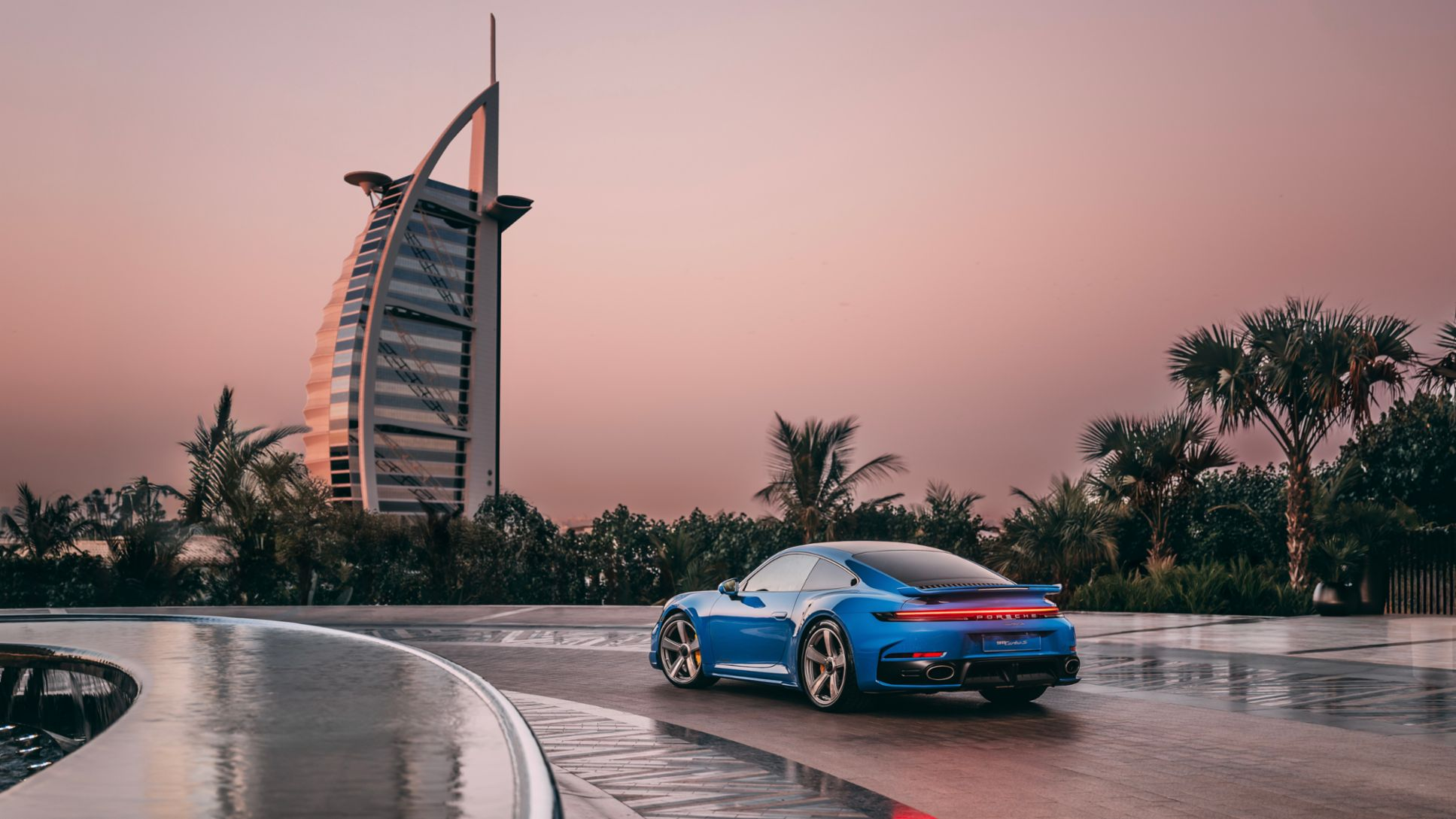 Blue Porsche at dusk in Dubai