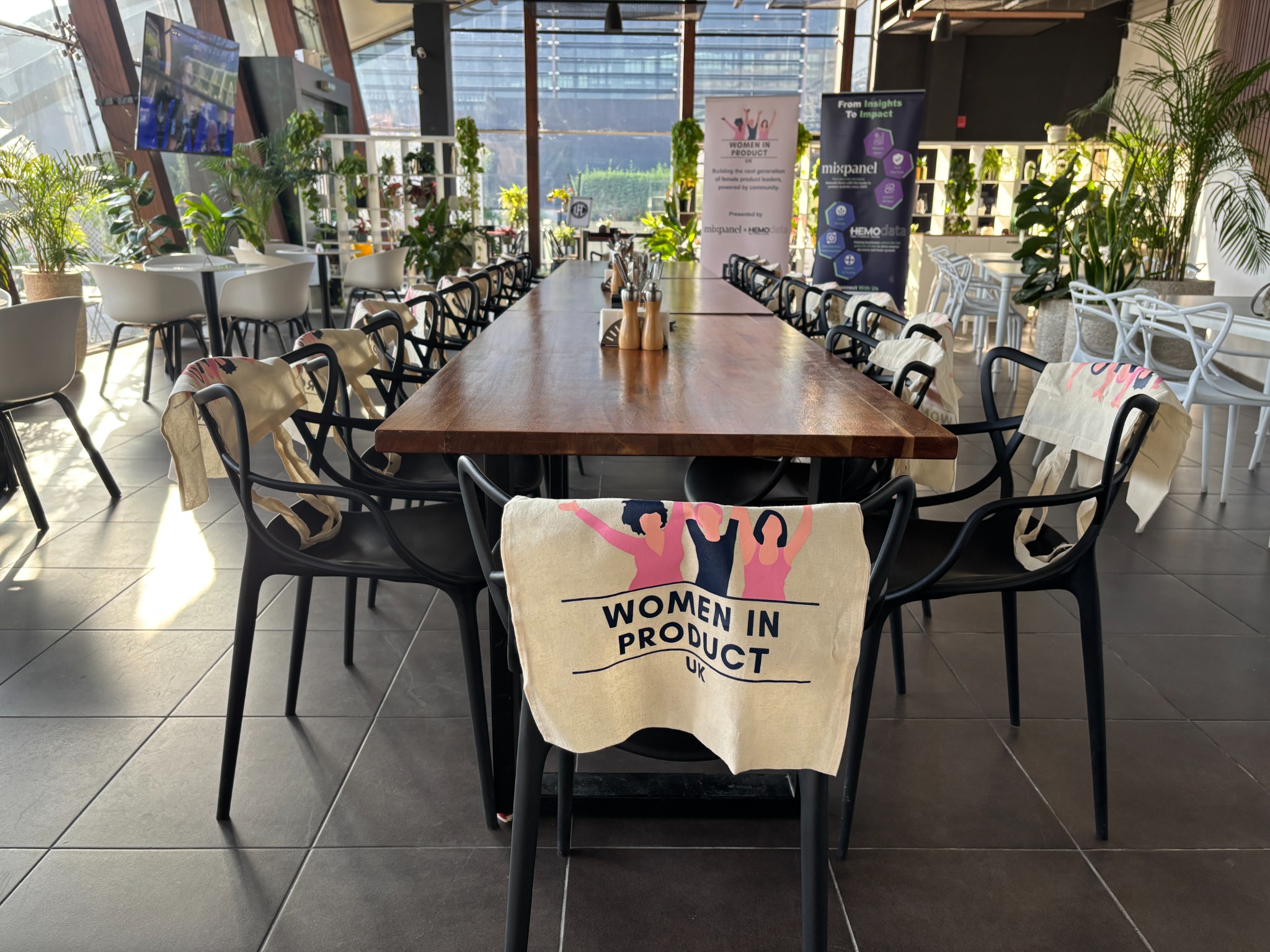 Women in Product UK event space with partner banners and attendee gifts